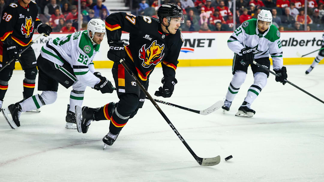 Mar 3, 2026; Calgary, Alberta, CAN; Calgary Flames defenseman Yan Kuznetsov (37) skates with the puck against the Dallas Stars during the first period at Scotiabank Saddledome. Mandatory Credit: Sergei Belski-Imagn Images
