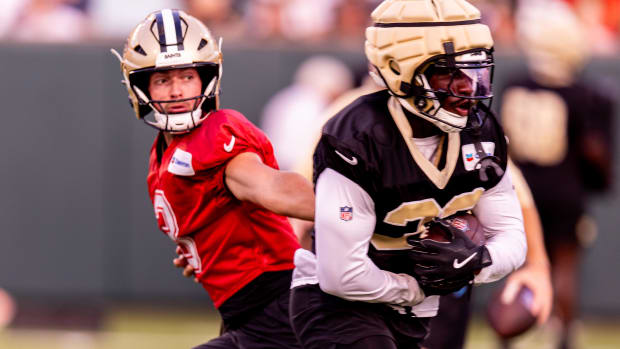 New Orleans Saints quarterback Jake Haener (3) hands the ball off to running back Jordan Mims (33) at Yulman Stadium 