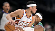 Nov 12, 2025; Dallas, Texas, USA; Dallas Mavericks guard Brandon Williams (10) steals the ball from Phoenix Suns guard Devin Booker (1) during the second quarter at the American Airlines Center. Mandatory Credit: Jerome Miron-Imagn Images