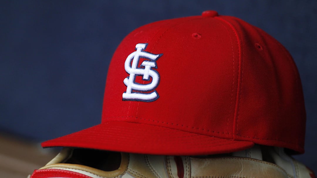 Oct 4, 2015; Atlanta, GA, USA; Detailed view of St. Louis Cardinals hat and glove in the dugout against the Atlanta Braves in the ninth inning at Turner Field. The Braves defeated the Cardinals 2-0. Mandatory Credit: Brett Davis-Imagn Images