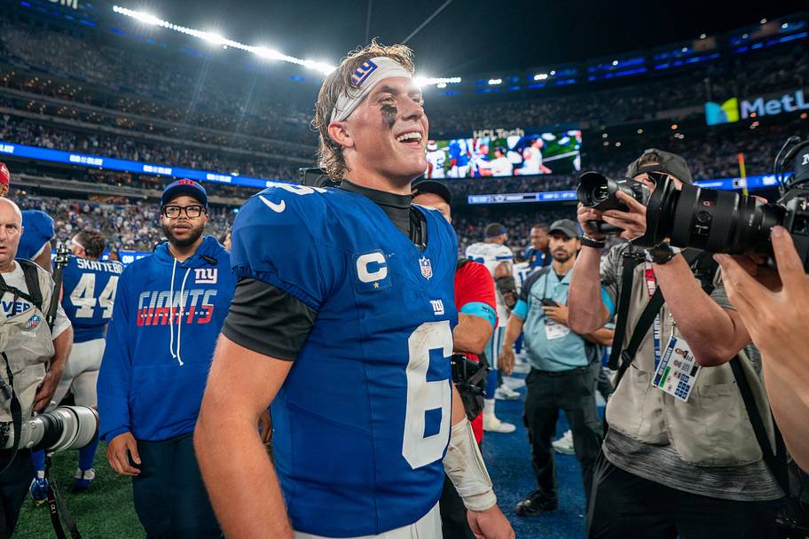Jaxson Dart smiles as he walks off the field.