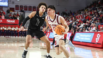 Nov 15, 2025; Queens, New York, USA;  St. John's basketball guard Dylan Darling (0) drives past William & Mary Tribe guard Kyle Pulliam (11) in the second half at Carnesecca Arena.