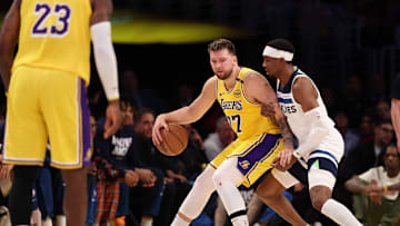 Apr 22, 2025; Los Angeles, California, USA; Los Angeles Lakers guard Luka Doncic (77) posts up against Minnesota Timberwolves forward Jaden McDaniels (3) during the first quarter of game two of first round for the 2024 NBA Playoffs at Crypto.com Arena. Mandatory Credit: Kiyoshi Mio-Imagn Images