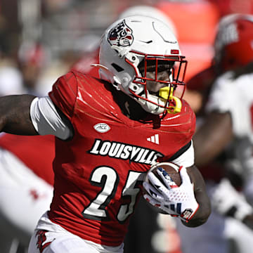 Sep 7, 2024; Louisville, Kentucky, USA;  Louisville Cardinals running back Isaac Brown (25) runs the ball against the Jacksonville State Gamecocks during the second half at L&N Federal Credit Union Stadium. Louisville defeated Jacksonville State 49-14. Mandatory Credit: Jamie Rhodes-Imagn Images