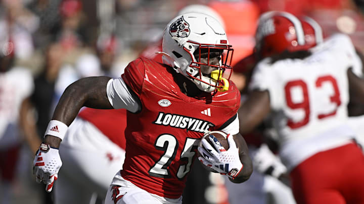 Sep 7, 2024; Louisville, Kentucky, USA;  Louisville Cardinals running back Isaac Brown (25) runs the ball against the Jacksonville State Gamecocks during the second half at L&N Federal Credit Union Stadium. Louisville defeated Jacksonville State 49-14. Mandatory Credit: Jamie Rhodes-Imagn Images