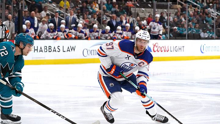 Edmonton Oilers center Connor McDavid controls the puck while defended by San Jose Sharks left wing William Eklund during the first period at SAP Center at San Jose. Mandatory Credit: David Gonzales-Imagn Images