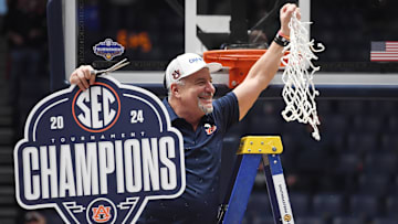 Auburn Tigers head coach Bruce Pearl cuts the net after defeating the Florida Gators in the SEC Tournament championship game at Bridgestone Arena