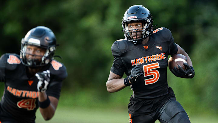 Hawthorne Hornets wide receiver Demetrius Brown (5) runs with the ball against the Newberry Panthers during the first half at Hawthorne High School Football Stadium in Hawthorne, FL on Friday, August 30, 2024. [Matt Pendleton/Gainesville Sun]