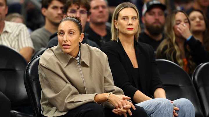 Nov 29, 2025; Phoenix, Arizona, USA; Phoenix Mercury former player Diana Taurasi (left) with wife Penny Taylor court side of the Phoenix Suns game against the Denver Nuggets at the Mortgage Matchup Center. Mandatory Credit: Mark J. Rebilas-Imagn Images