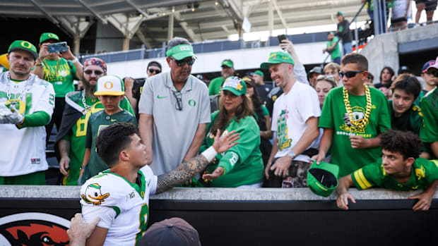 Oregon Ducks quarterback Dillon Gabriel (8) greets family after winning the annual rivalry game against the Oregon State Beav