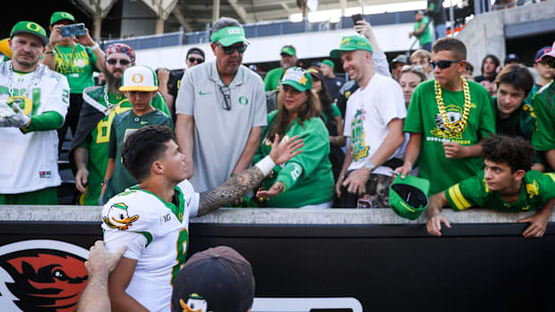 Oregon Ducks quarterback Dillon Gabriel (8) greets family after winning the annual rivalry game against the Oregon State Beav