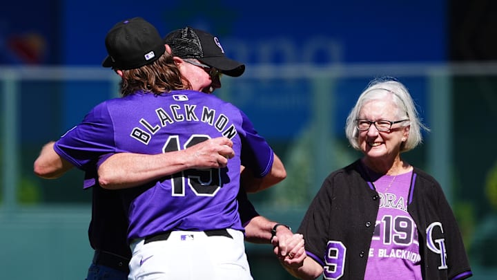Colorado Rockies outfielder Charlie Blackmon hugs his dad and mom after they threw out a first pitch. Colorado Rockies outfielder Charlie Blackmon hugs his dad and mom after they threw out a first pitch.