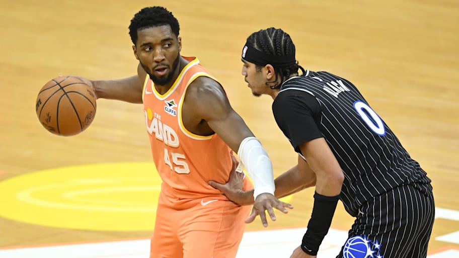 Magic guard Anthony Black defends Cavaliers guard Donovan Mitchell.