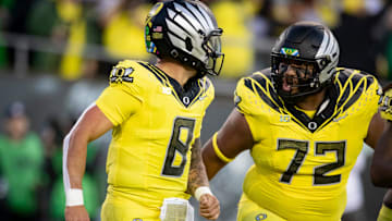 Oregon Ducks quarterback Dillon Gabriel, left, and offensive lineman Iapani Laloulu celebrate a touchdown run by Gabriel as the Ducks host the Spartans Friday, Oct. 4, 2024 at Autzen Stadium in Eugene, Ore.
