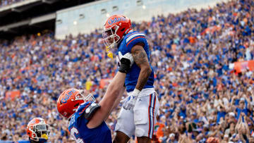 Florida Gators offensive lineman Jake Slaughter (66) holds up Florida Gators wide receiver Eugene Wilson III (3) after a touchdown during the second half at Steve Spurrier Field at Ben Hill Griffin Stadium in Gainesville, FL on Saturday, October 7, 2023. [Matt Pendleton/Gainesville Sun]