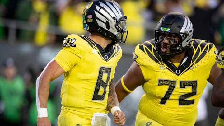 Oregon Ducks quarterback Dillon Gabriel, left, and offensive lineman Iapani Laloulu celebrate a touchdown run by Gabriel as the Ducks host the Spartans Friday, Oct. 4, 2024 at Autzen Stadium in Eugene, Ore.