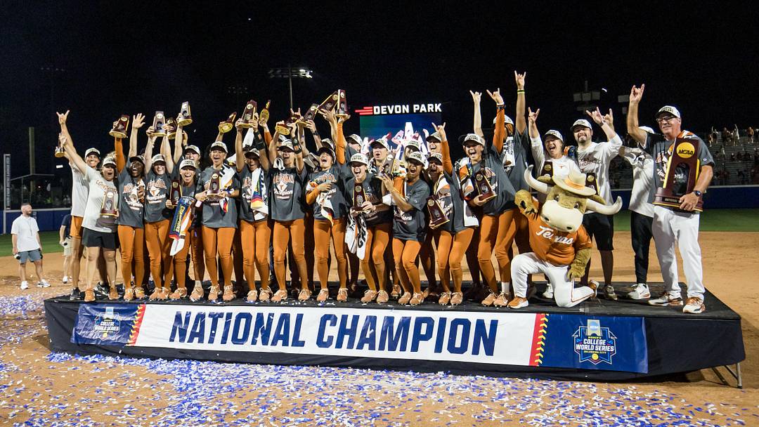 Texas Longhorns players and coaches pose for a group photo after defeating the Texas Tech Red Raiders to win the NCAA Women’s College World Series championship series at Devon Park. Texas Longhorns players and coaches pose for a group photo after defeating the Texas Tech Red Raiders to win the NCAA Women’s College World Series championship series at Devon Park.