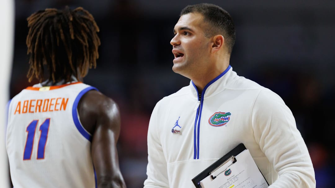 Nov 11, 2024; Gainesville, Florida, USA; Florida Gators director of basketball strategy and analytics Jonathan Safir talks with Florida Gators guard Denzel Aberdeen (11) during a timeout against the Grambling State Tigers during the second half at Exactech Arena at the Stephen C. O'Connell Center. Mandatory Credit: Matt Pendleton-Imagn Images