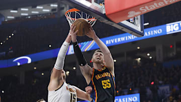 May 5, 2025; Oklahoma City, Oklahoma, USA; Oklahoma City Thunder center Isaiah Hartenstein (55) drives to the basket against Denver Nuggets center Nikola Jokic (15) during the second half in game one of the second round for the 2025 NBA Playoffs at Paycom Center.