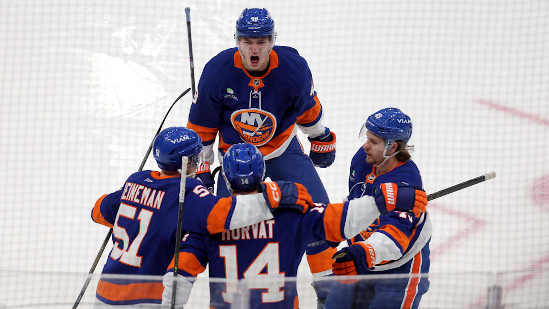 Dec 4, 2025; Elmont, New York, USA; New York Islanders center Bo Horvat (14) celebrates his goal against the Colorado Avalanche with left wing Emil Heineman (51) and defenseman Matthew Schaefer (48) and right wing Max Shabanov (49) during the second period at UBS Arena. Mandatory Credit: Brad Penner-Imagn Images