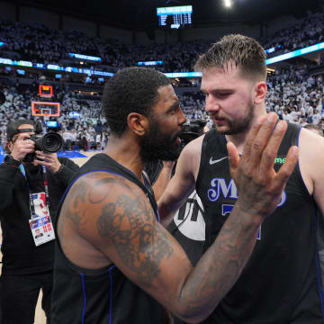 May 24, 2024; Minneapolis, Minnesota, USA; Dallas Mavericks guard Kyrie Irving (11) and guard Luka Doncic (77) celebrate after defeating the Minnesota Timberwolves in game two of the western conference finals for the 2024 NBA playoffs at Target Center. Mandatory Credit: Brad Rempel-USA TODAY Sports