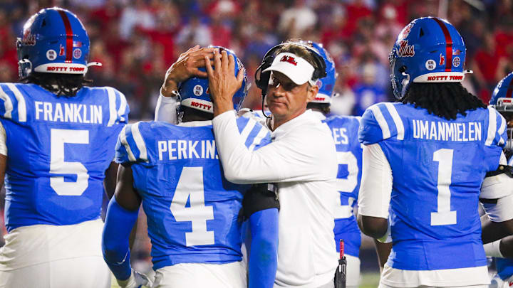 Nov 15, 2025; Oxford, Mississippi, USA; Mississippi Rebels head coach Lane Kiffin embraces linebacker Suntarine Perkins (4) during the second half against the Florida Gators at Vaught-Hemingway Stadium. Mandatory Credit: Petre Thomas-Imagn Images