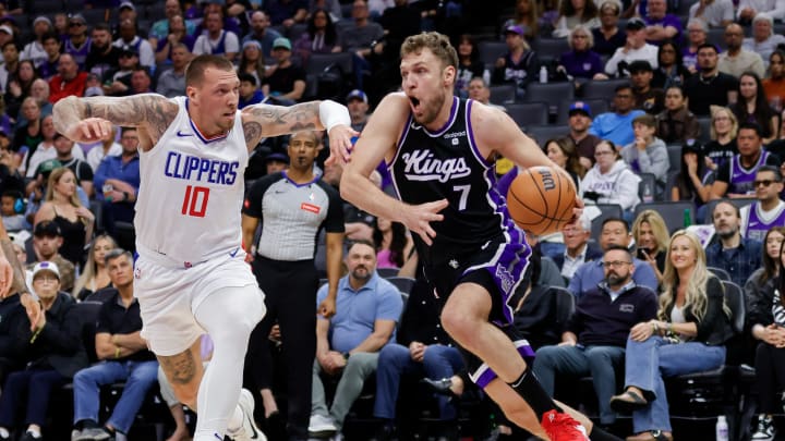 Apr 2, 2024; Sacramento, California, USA; Sacramento Kings forward Sasha Vezenkov (7) drives to the basket against LA Clippers center Daniel Theis (10) during the second quarter at Golden 1 Center. Mandatory Credit: Sergio Estrada-USA TODAY Sports