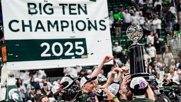 Michigan State basketball players celebrate their Big Ten regular season championships trophy after 79-62 win over Michigan at Breslin Center in East Lansing on Sunday, March 9, 2025.