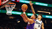Oct 22, 2025; Phoenix, Arizona, USA; Phoenix Suns guard Devin Booker (1) shoots the ball against Sacramento Kings guard Nique Clifford (5) during the first quarter at Mortgage Matchup Center. Mandatory Credit: Mark J. Rebilas-Imagn Images