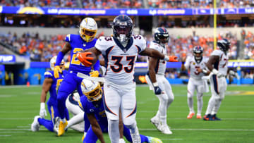 Dec 10, 2023; Inglewood, California, USA;  Denver Broncos running back Javonte Williams (33) scores a touchdown against 5e against the Los Angeles Chargers during the first half at SoFi Stadium. Mandatory Credit: Gary A. Vasquez-USA TODAY Sports