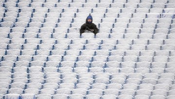Jan 2, 2022; Orchard Park, New York, USA; A fan sits in the snow covered stands prior to the game