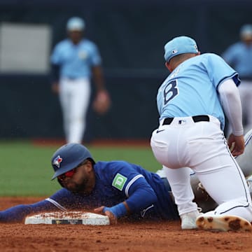 Toronto Blue Jays outfielder Steward Berroa (37) slides safe into second base as Tampa Bay Rays second base Brandon Lowe (8) attempted to tag him out during the second inning at Charlotte Sports Park on March 9.