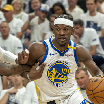May 14, 2025; Minneapolis, Minnesota, USA; Golden State Warriors forward Jimmy Butler III (10) drives to the basket past Minnesota Timberwolves forward Jaden McDaniels (3) in the second half during game five of the second round for the 2025 NBA Playoffs at Target Center. Mandatory Credit: Jesse Johnson-Imagn Images