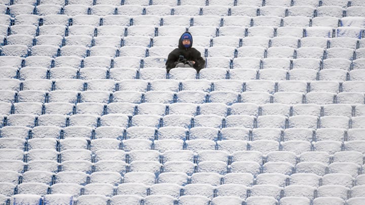 Jan 2, 2022; Orchard Park, New York, USA; A fan sits in the snow covered stands prior to the game