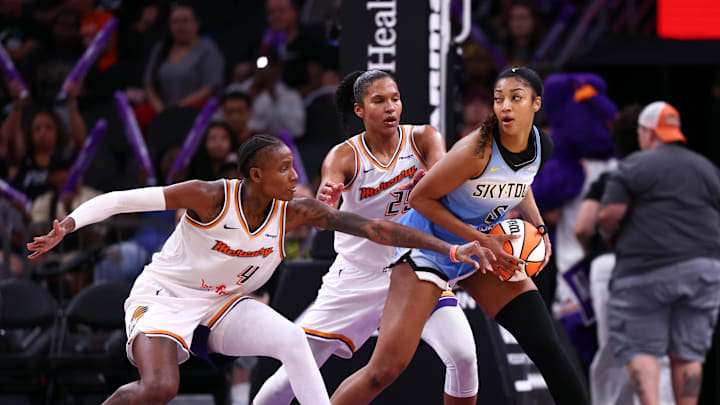 Aug 28, 2025; Phoenix, Arizona, USA; Chicago Sky forward Angel Reese (5) controls the ball against Phoenix Mercury forward Natasha Mack (4) and forward Alyssa Thomas (25) in the second half at Phx Arena. Mandatory Credit: Mark J. Rebilas-Imagn Images
