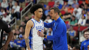Mar 23, 2025; Raleigh, NC, USA; Duke basketball guard Tyrese Proctor (5) and Duke Blue Devils head coach Jon Scheyer react after a play during the first half against the Baylor Bears in the second round of the NCAA Tournament at Lenovo Center. 