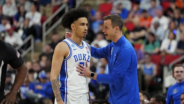 Mar 23, 2025; Raleigh, NC, USA; Duke basketball guard Tyrese Proctor (5) and Duke Blue Devils head coach Jon Scheyer react after a play during the first half against the Baylor Bears in the second round of the NCAA Tournament at Lenovo Center. 
