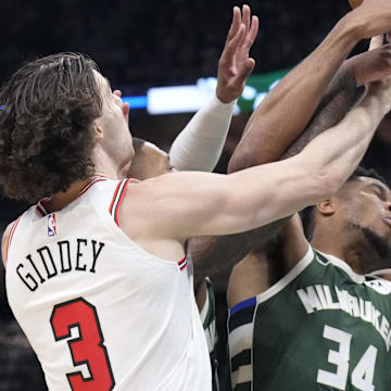 Oct 25, 2024; Milwaukee, Wisconsin, USA; Chicago Bulls guard Josh Giddey (3) and Milwaukee Bucks forward Giannis Antetokounmpo (34) battle for possession of the ball in the first half at Fiserv Forum. Mandatory Credit: Michael McLoone-Imagn Images