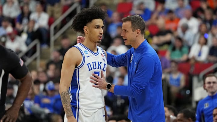 Mar 23, 2025; Raleigh, NC, USA; Duke basketball guard Tyrese Proctor (5) and Duke Blue Devils head coach Jon Scheyer react after a play during the first half against the Baylor Bears in the second round of the NCAA Tournament at Lenovo Center. 