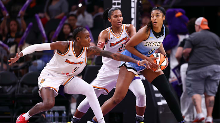 Aug 28, 2025; Phoenix, Arizona, USA; Chicago Sky forward Angel Reese (5) controls the ball against Phoenix Mercury forward Natasha Mack (4) and forward Alyssa Thomas (25) in the second half at Phx Arena. Mandatory Credit: Mark J. Rebilas-Imagn Images