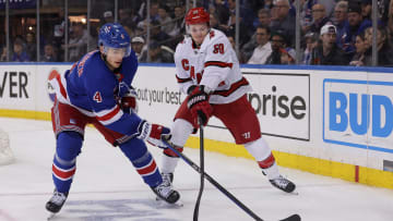 May 13, 2024; New York, New York, USA; New York Rangers defenseman Braden Schneider (4) fights for the puck against Carolina Hurricanes left wing Jake Guentzel (59) during the third period of game five of the second round of the 2024 Stanley Cup Playoffs at Madison Square Garden. Mandatory Credit: Brad Penner-USA TODAY Sports