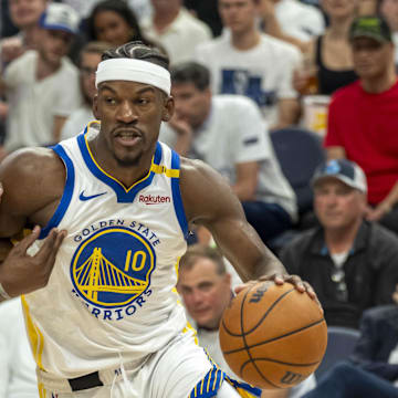 May 14, 2025; Minneapolis, Minnesota, USA; Golden State Warriors forward Jimmy Butler III (10) drives to the basket past Minnesota Timberwolves forward Jaden McDaniels (3) in the second half during game five of the second round for the 2025 NBA Playoffs at Target Center. Mandatory Credit: Jesse Johnson-Imagn Images