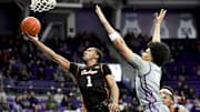 Feb 12, 2025; Fort Worth, Texas, USA;  Oklahoma State Cowboys guard Bryce Thompson (1) shoots past TCU Horned Frogs forward David Punch (15) during the second half at Ed and Rae Schollmaier Arena. Mandatory Credit: Kevin Jairaj-Imagn Images