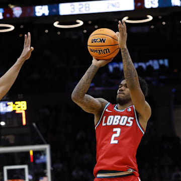 Mar 23, 2025; Cleveland, OH, USA; New Mexico Lobos guard Donovan Dent (2) shoots the ball over Michigan State Spartans guard Jeremy Fears Jr. (1) in the second half during the NCAA Tournament Second Round at Rocket Arena.