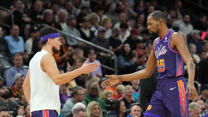 Feb 29, 2024; Phoenix, Arizona, USA; Phoenix Suns guard Devin Booker (1) and Phoenix Suns forward Kevin Durant (35) slap hands during the first half of the game against the Houston Rocketsat Footprint Center. Mandatory Credit: Joe Camporeale-Imagn Images