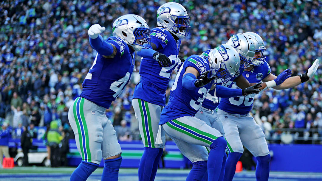 Nov 30, 2025; Seattle, Washington, USA; Seattle Seahawks safety Ty Okada (39) celebrates with his teammates after retrieving a fumble during the second half against the Minnesota Vikings at Lumen Field. Mandatory Credit: Kevin Ng-Imagn Images