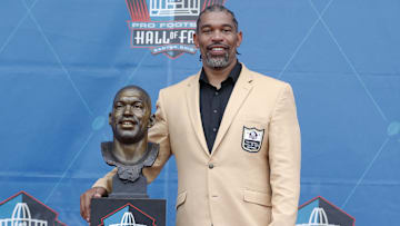 Aug 3, 2024; Canton, OH, USA;  Class of 2024 member Julius Peppers poses with his bust at the enshrinement ceremony at Tom Benson Hall of Fame Stadium.