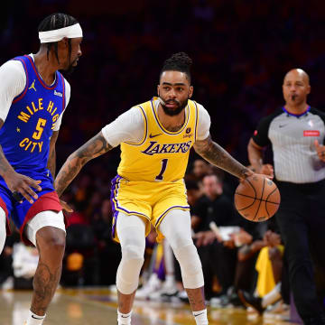 Apr 25, 2024; Los Angeles, California, USA; Los Angeles Lakers guard D'Angelo Russell (1) moves the ball against Denver Nuggets guard Kentavious Caldwell-Pope (5) during the second half in game three of the first round for the 2024 NBA playoffs at Crypto.com Arena. Mandatory Credit: Gary A. Vasquez-USA TODAY Sports