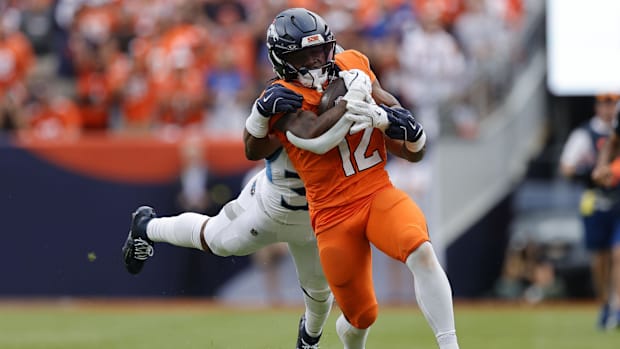 Denver Broncos running back RJ Harvey (12) rushes the ball against the Tennessee Titans in the second half.