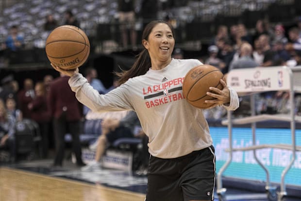 LA Clippers assistant video coordinator Natalie Nakase helps warm up her team 